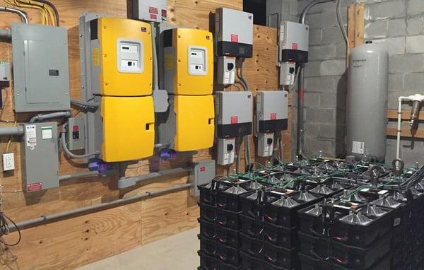 System utilizes off-grid capable inverters and salt-water battery storage for autonomous backup if the grid goes down.