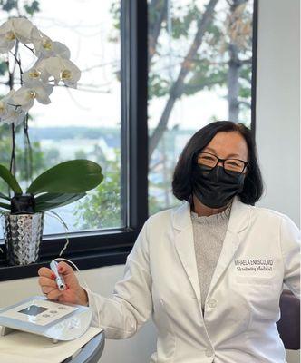 Dr. Enescu prepping for Microneedling treatment using the Exceed Microneedling device