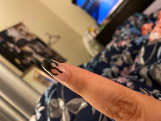 The uneven polish at the tip of my nail and what was supposed to be flames