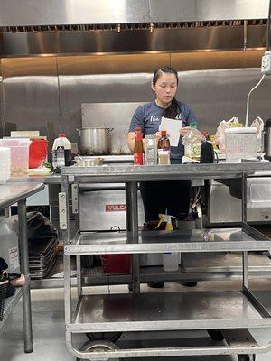 Eggroll Lady demonstrating her cooking techniques