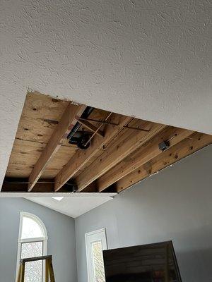 Torn up ceiling from a leaky upstairs shower