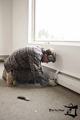 Jason Essig, Owner of Top Knot Floors, LLC. working very hard to install a "floating floor" in my photography studio.