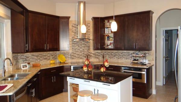 Cabinets, island, countertops, and wall tiles