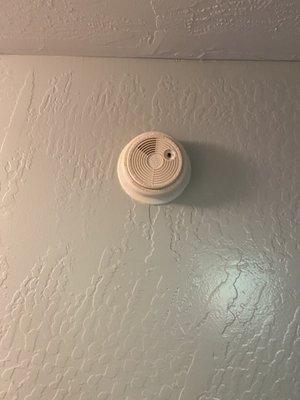 Old broken wired smoke alarm