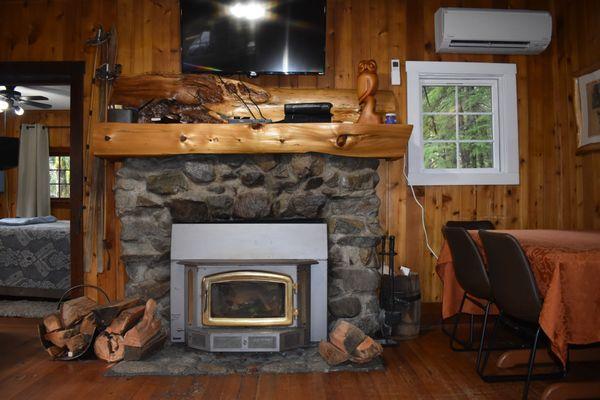 Old stone fireplace with wood stove insert.