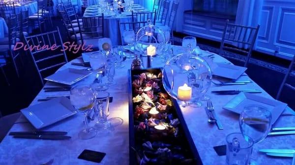 Floating candle globes along with pinspot lighting helped turn this tablescape into a multidimensional centerpiece.