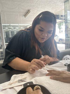 Clara, doing the manicure and pedicure.