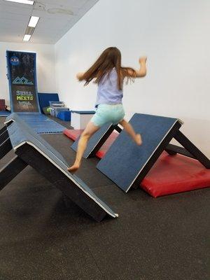 Floating steps leading to the warped wall at Adventure Recreation Center Obstacle Course Gymnastics class in the Petaluma Premium Outlets