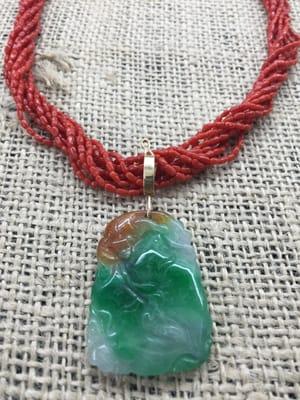 Multi strand of italian natural Coral with a natural Carved jade pendant set in 14KG