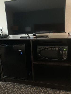 TV, refrigerator, and microwave combo