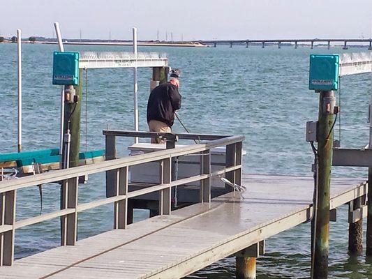 Pressure washing a dock to remove bird droppings and grime every 2 months in St. Petersburg.