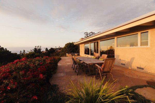 Backyard flagstone patio with bouganvilla and ocean views.