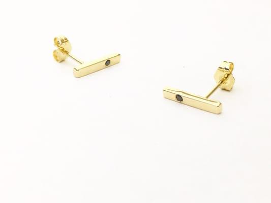 18k yellow gold with black diamond bar stud earrings.