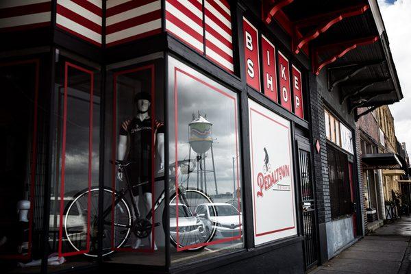 Pedaltown Bicycle Company is located across the street from the Broad Ave water tower