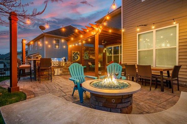 Custom round gas fire pit and seating wall with L-Shaped Kitchen and raised bar (Charlotte, NC).