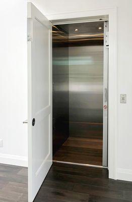 Sugarmill Series home elevator design with stainless steel walls.