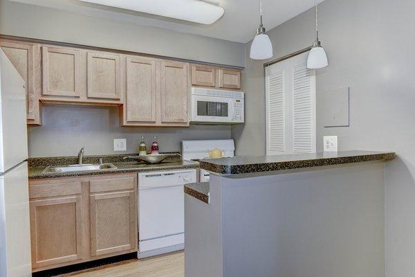 Fully-equipped kitchens feature a pantry, space-saver microwave, and breakfast bar.