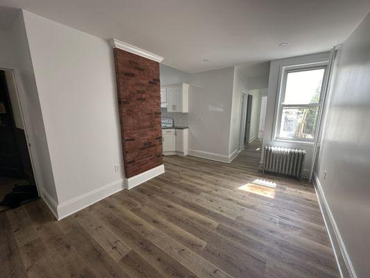 Living room and preserved chimney wall.