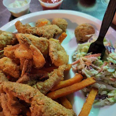 Catfish nuggets with shrimp, fries and coleslaw.