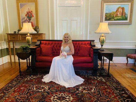 Beautiful bride on our antique red sofa