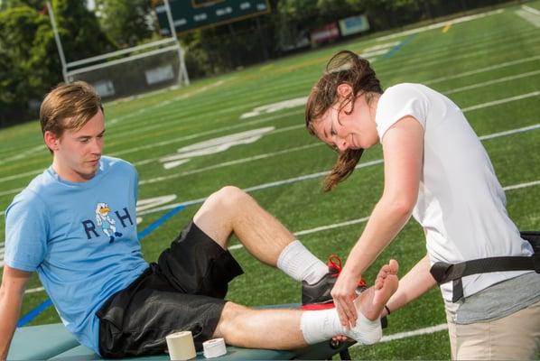 Pivot athletic trainer Katie Cicia working with a student athlete.