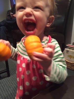 Libby playing with the pumpkins in the waiting room.