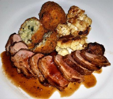 Duck breast w/ mission fig demi, arancini & roasted cauliflower.