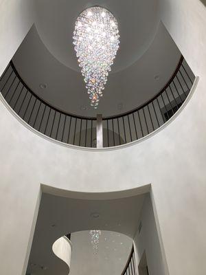 2 8 ft crystal chandeliers - 1 on entry and 1 on staircase