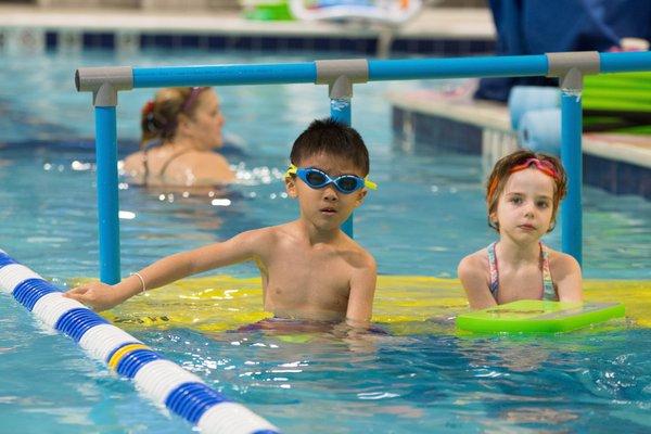 Kids sitting on platform waiting for their turn to swim!