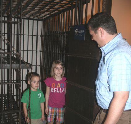 Go in the original City of Rogers jail cell.