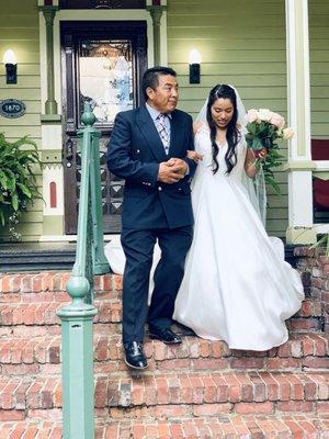 Bride and her father on the way to her courtyard wedding