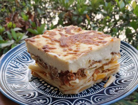 Authentic Greek meal: pasticio (Layered thick macaroni, tomatoes, simmered ground beef, grated cheeses, topped with Mornay sauce)