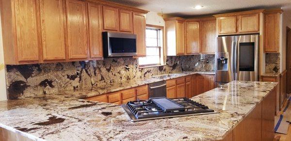 Crazy Horse White granite with full height backsplash.