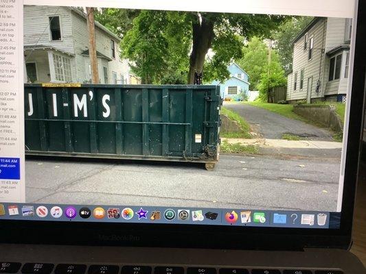 Clearly not enough room between neighboring driveway when dumpster door opened.