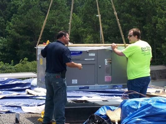 One Call setting an a/c unit on the roof of Lewis Elementary School in Kennesaw, GA in the summer of 2013.