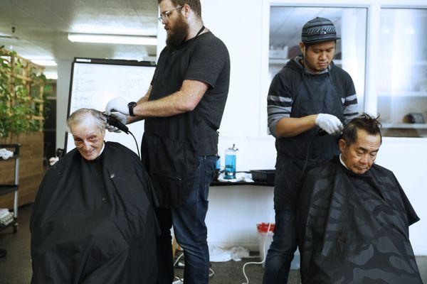 Free haircuts are offered to the neighborhood and those experiencing homelessness.