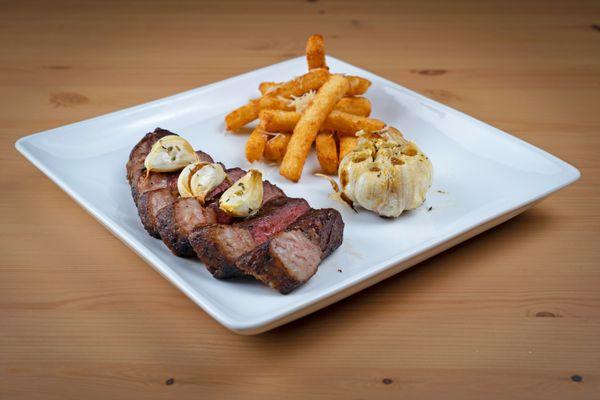 Top Sirloin Cap with yucca fries and roasted garlic