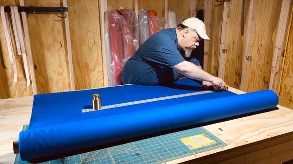 The owner cutting material for a canvas tote bag.