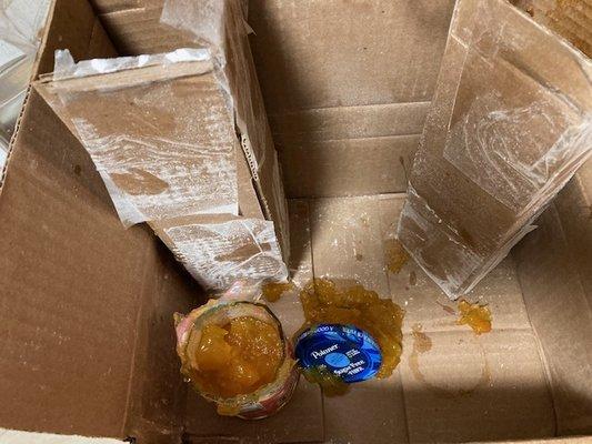 Jelly jars stacked end to end in cardboard, but no packing at ends, or between bottles.
 
 Not shown, a ruptured bag of flour