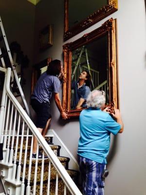 Helpers from Chao Framing installing mirror collection on 20' h wall