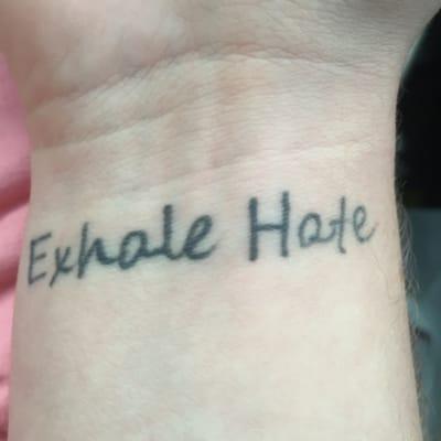 The fade of the tattoo as well as the messed up word "hate"