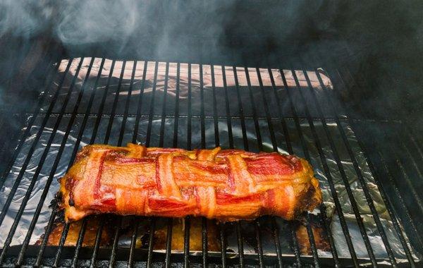 A bacon baby nearing completion on the Traeger.