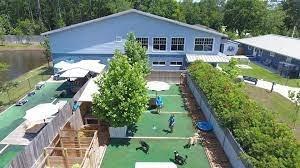 12 play yards equipped w/ water, shady areas, misters, boardwalks, raised cots; 4 indoor areas; dog's play style, energy, size & tolerance