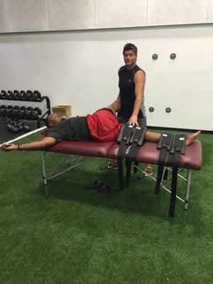 I'm doing Fascialstretch therapy on a defensive starter for the University of Utah football team.