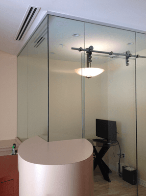 Glass partition with sliding door