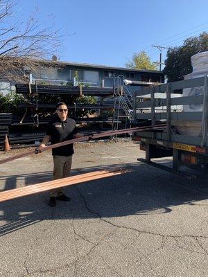 Victor loading up copper pipe for a delivery!