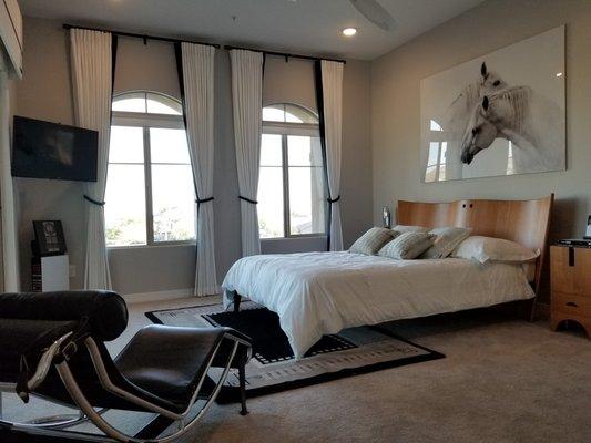 Modern Master Bedroom with curtain side panels over arched windows.