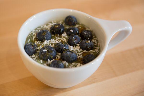 Matcha Chia Pudding with blueberries, shaved coconut, & honey