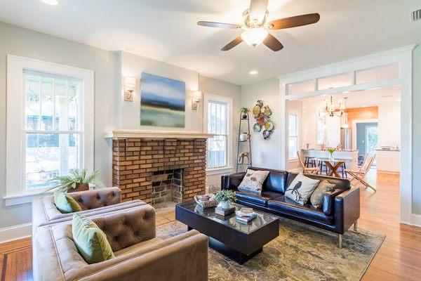 Full remodeled bungalow: Living room with original fireplace, wood floors and windows.