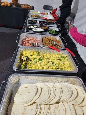 Breakfast Taco Bar- Jerk Chicken, Glazed Ham, Impossible Sausage, Jerk Lamb and Eggs.  Their toppings are !